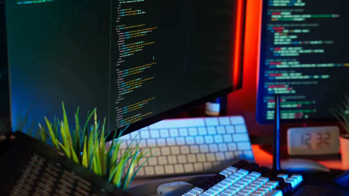 A developer workspace with code on two monitors